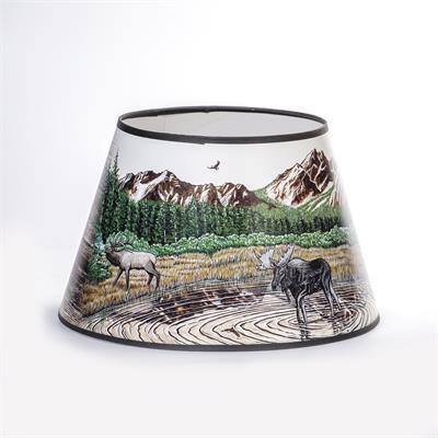 Rustic Mountain Scene with lake, Elk, and Moose  Bring mountain flair to your Aladdin table lamp. This exclusive parchment shade features artwork by renowned local artist Dennis Lipp, perfect for adding a touch of décor to your home. Plus, it helps diffus