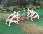 Oxers are a set of fences placed several feet apart that give width to an obstacle, encouraging a greater effort from the horse. This wooden jump is painted in colorful red and white.